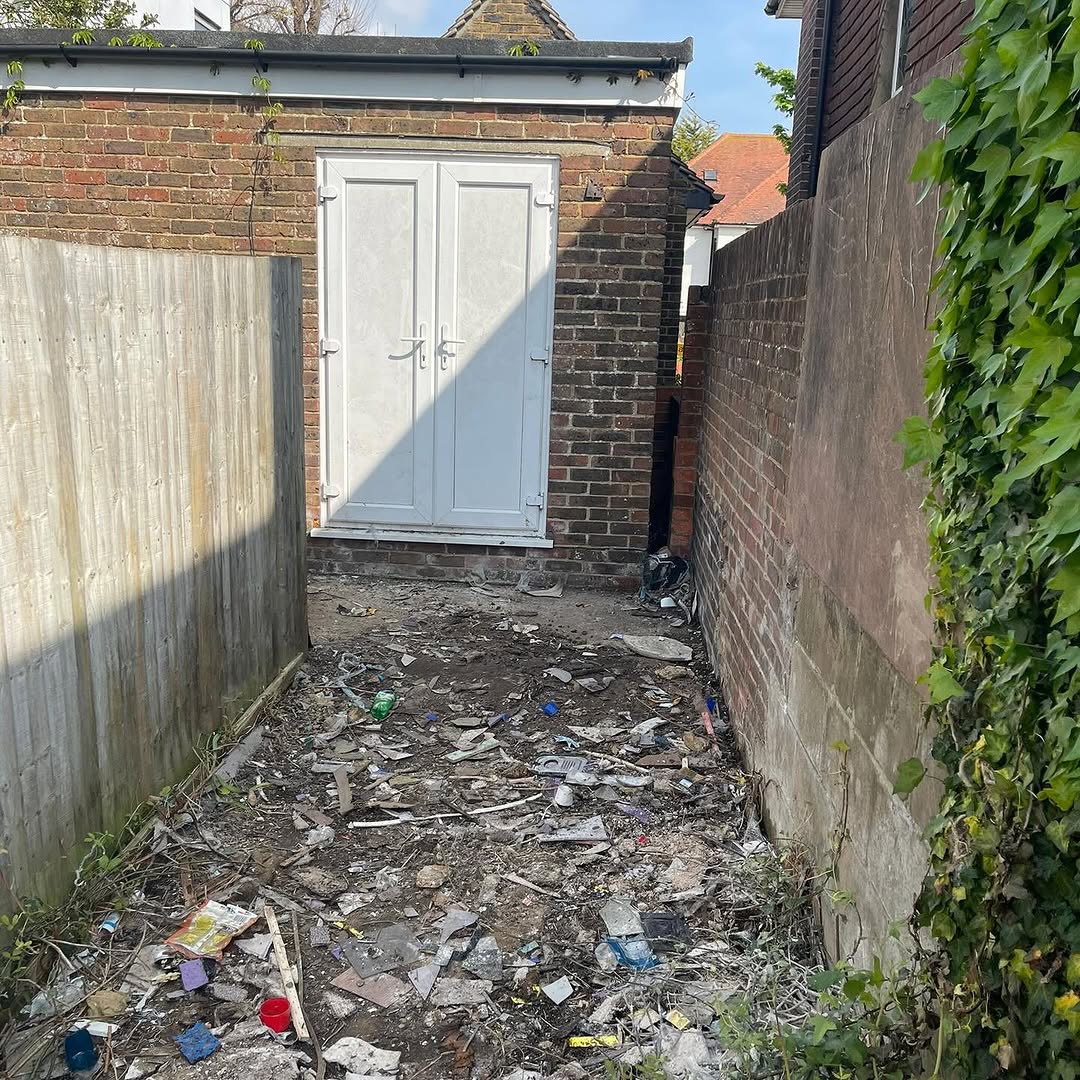 Back alley strewn with debris before clearance