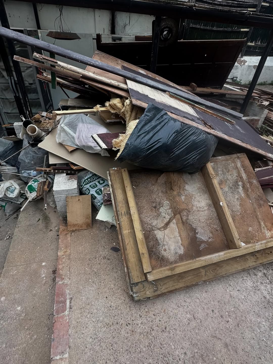 Commercial waste clearance — doors and timber outside a Brighton building