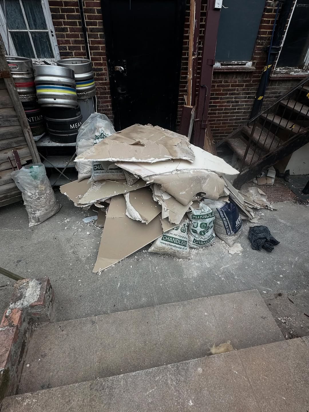 Plasterboard and commercial waste piled outside a Brighton bar