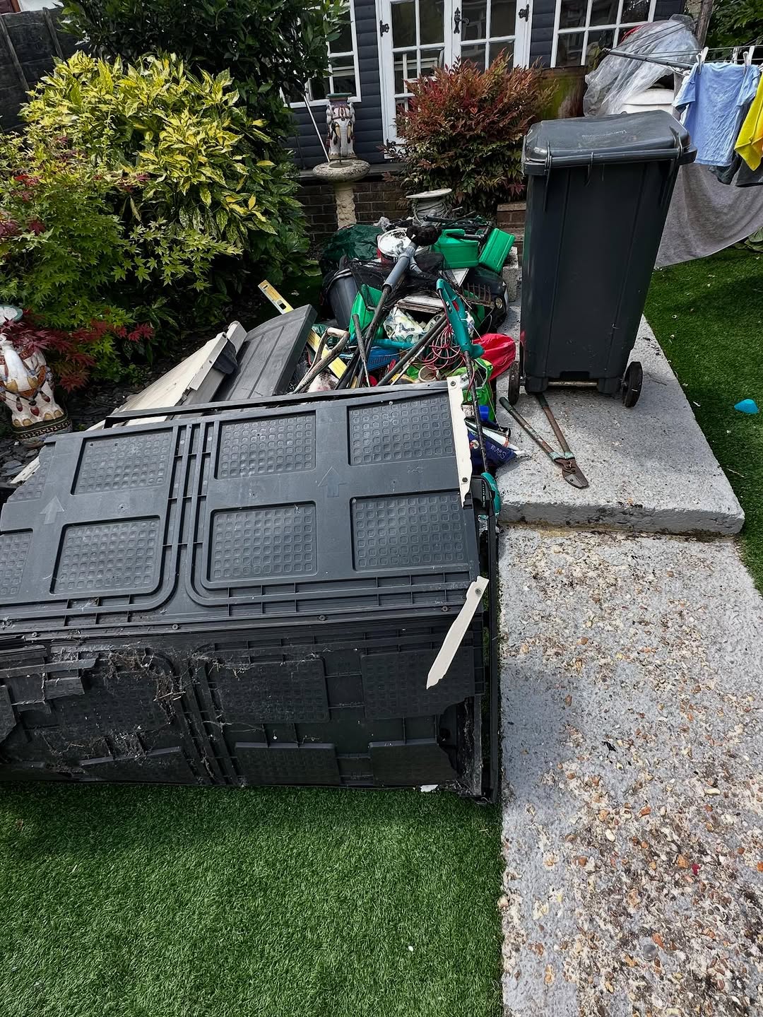 Garden tools and storage items ready for outdoor clearance